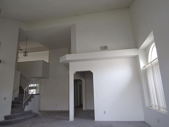 Living room to dinning area, loft staircase and ha