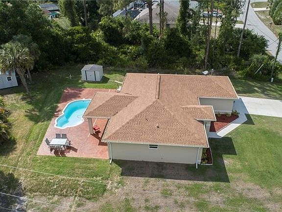 View of pool/deck and vacant lot to the right.