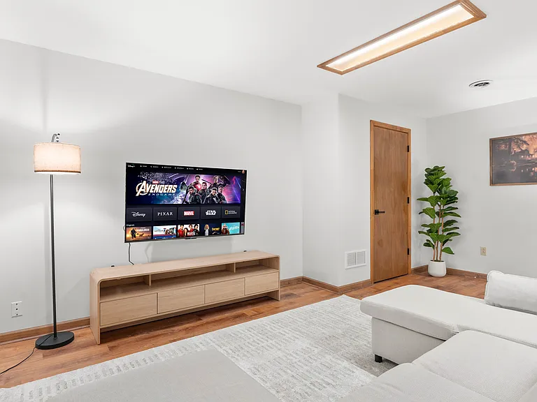 Flexible basement bedroom/lounge with a convertible sofa for comfortable seating or sleeping with pool table.