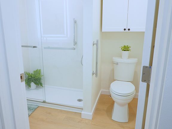 Modern bathroom with new rain head shower system, soft close cabinets, and quartz countertops