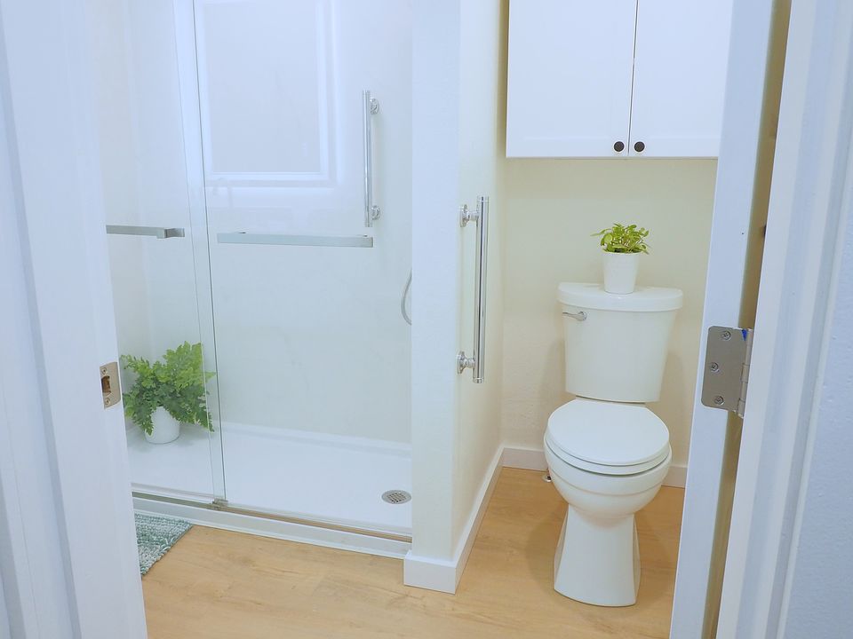 Modern bathroom with new rain head shower system, soft close cabinets, and quartz countertops