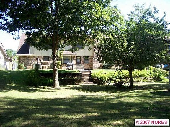 huge backyard with terraced landscaping backed by treed greenbelt