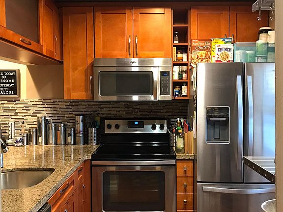 Modern stainless steel appliances and custom cabinets includ