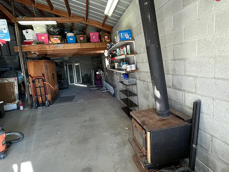 garage bay #1 with electric door opener, wood stove