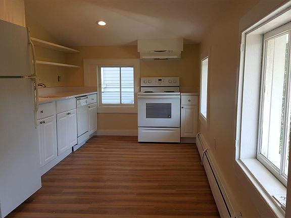 Newly updated Kitchen, from Dining Area, with dishwasher, disposal, electric range and range hood.