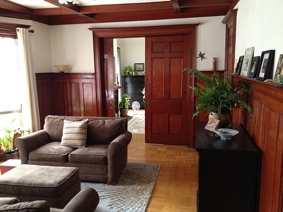 Living room looking into bedroom with pocket doors
