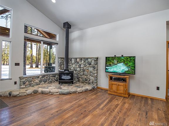 Real river rock stoned hearth for the wood-burning stove. So cozy!