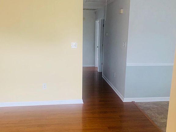 Living room leads to eat-in kitchen, and hallway that leads to 3 bedrooms with 2 baths