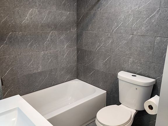 Newly renovated bathroom. Floor to ceiling tile. New fixtures.