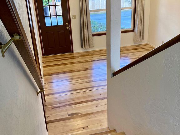 View from second floor dining room to the first floor living room & front entrance. New recessed lighting.