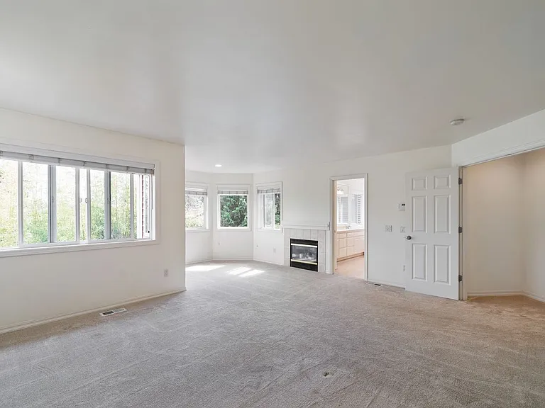 Primary suite w/ plenty of windows and sitting area and fireplace