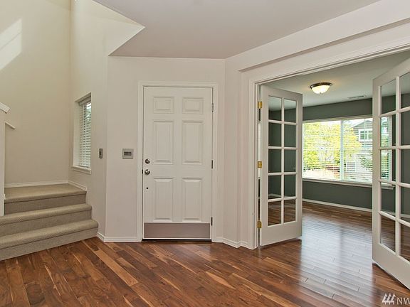 Spacious entry features stunning hardwoods and dual french doors into main floor office/den. 