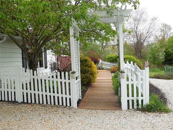 White picket fence walkway to front door entrance