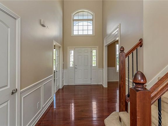 2 story gleaming hardwood entry with library type paneling