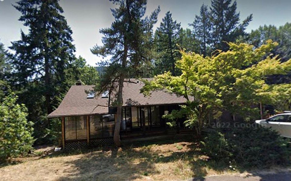 House from front. The guest house entrance is to the right of the driveway, a few steps down.