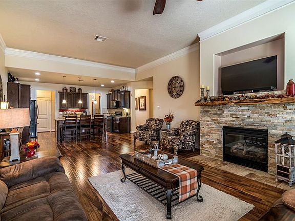 Family Room Open to Kitchen with stacked stone Fireplace Focal