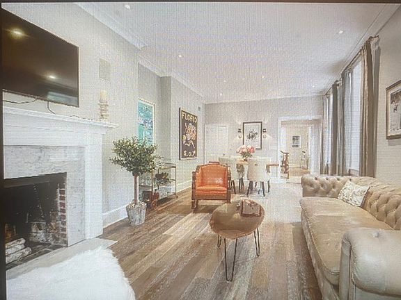Stunning living room high ceilings, floor-to-ceiling windows and bountiful wall space!