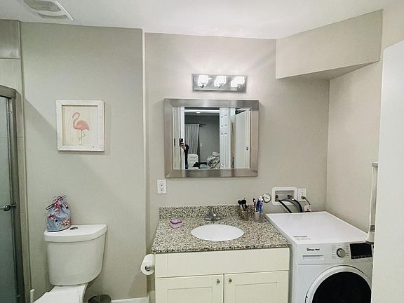 Includes washer machine, walk-in closet and glass shower doors.