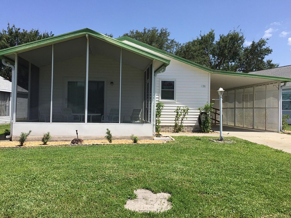 Front of home with screened lanai patio.