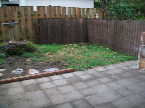 Small fenced yard with covered patio