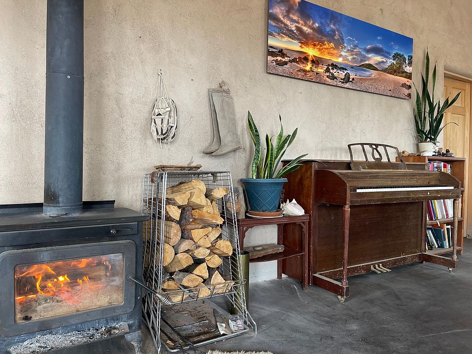 Wood burning stove, piano in great room.