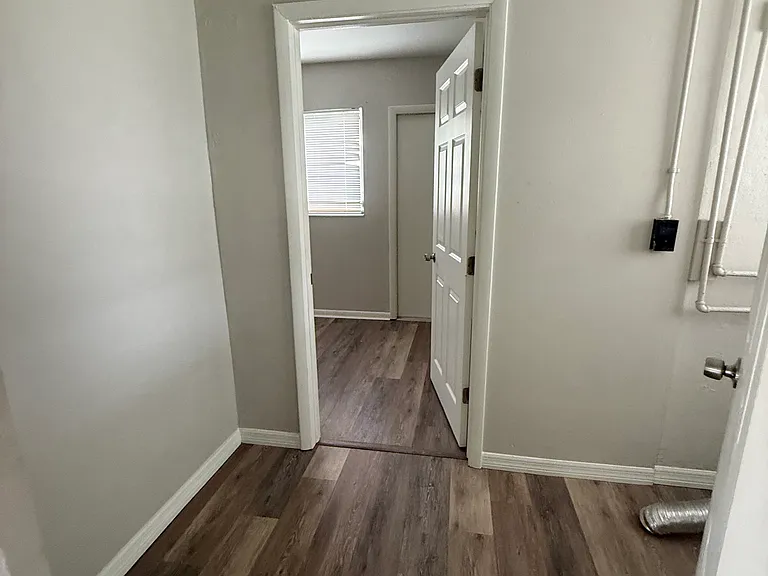 This smaller area is between the kitchen and leads into the master bedroom. To the right, where you can see a dryer vent on the floor, is where you could have a stackable washer and dryer