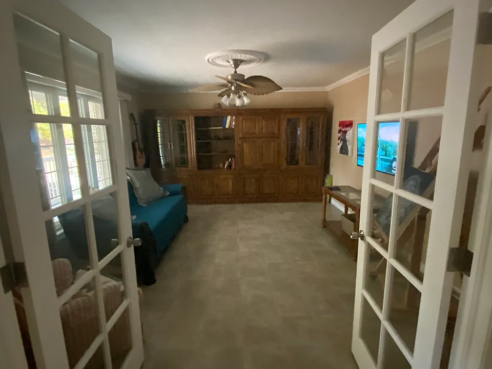 French doors leading into the front room with "built in" cabinets for storage