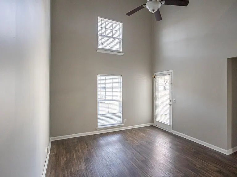 Spacious living room with hardwood-style flooring and vaulted ceiling