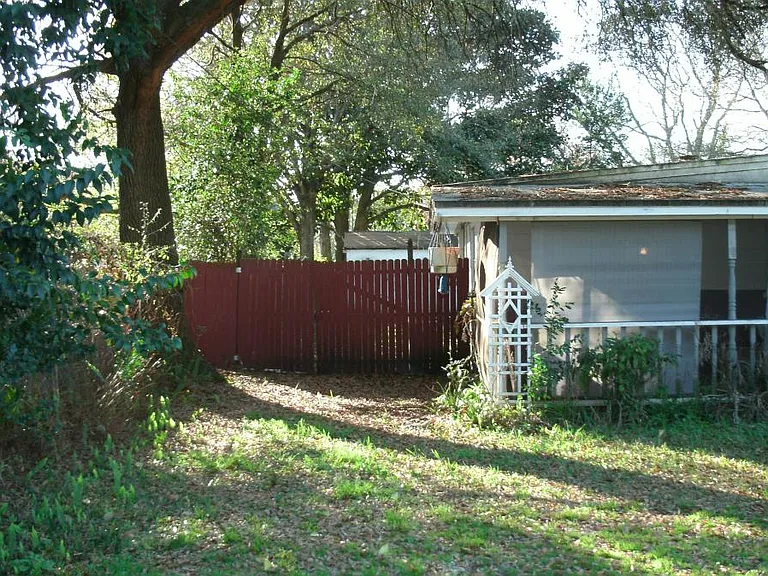 screened porch, front yard left with gate to back yard