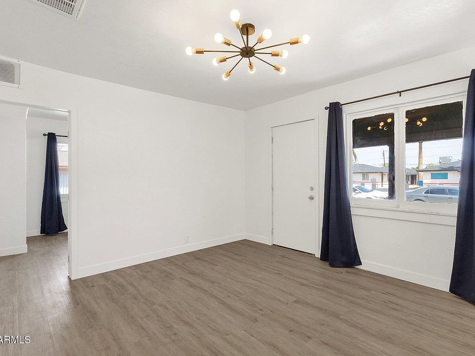 Bright, open living area with stylish LVP flooring and fireplace.