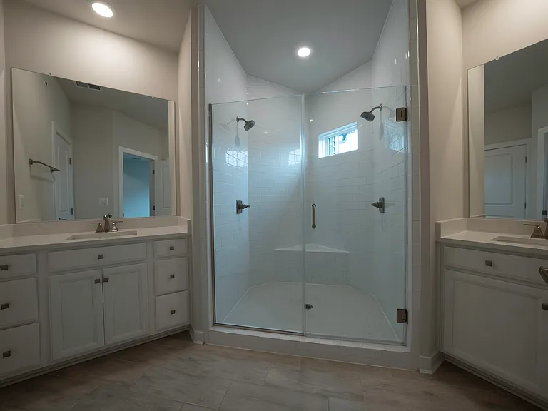 Owner's Bathroom features his and her vanities and Roman shower with dual shower heads