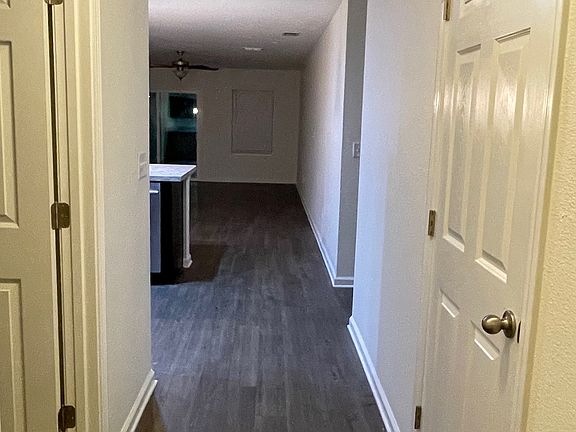 The front hallway leads to one bedroom, a coat closet, and an open-concept living area.