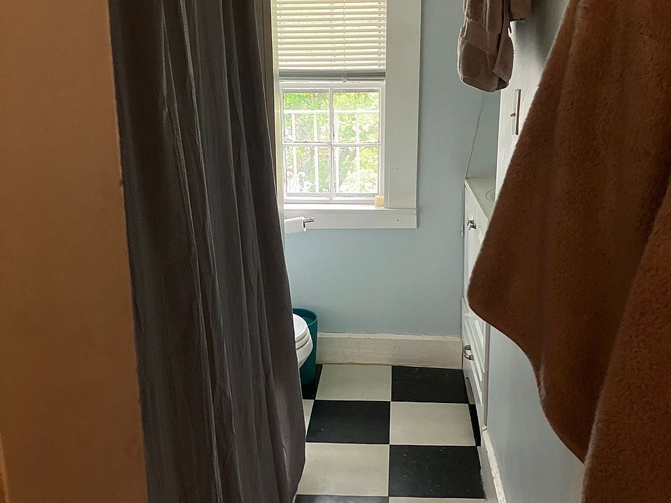 Door into bathroom w full tub w new subway tiles