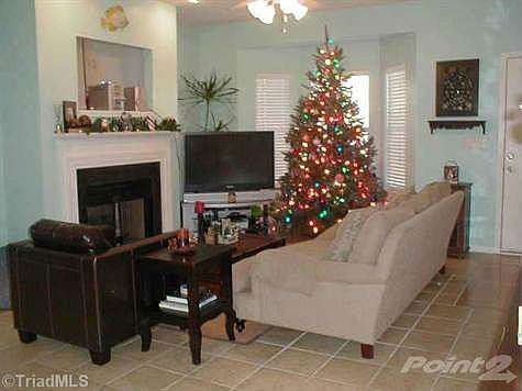 Living Room Features Ceramic Tile Flooring and a Fireplace