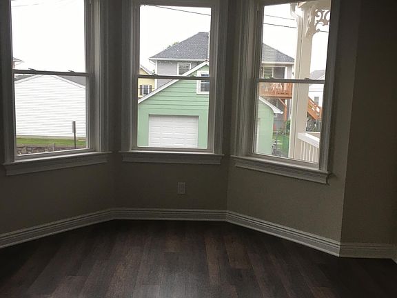 Large front bedroom. Three corner windows with another window, not in the picture, to the left.