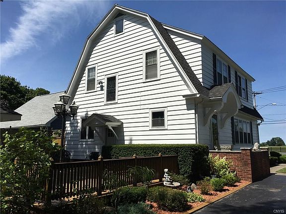 Backside of home.  Driveway stretches from Grant Blvd at front entrance (across the street, you look out toward expanse of greenspace near Woodlawn Cemetery) to back entrance of driveway off Feigel Ave, next to Feigel Parka city owned "greenspace" park.  