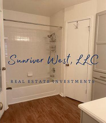 Primary bathroom with dual walk-in closets