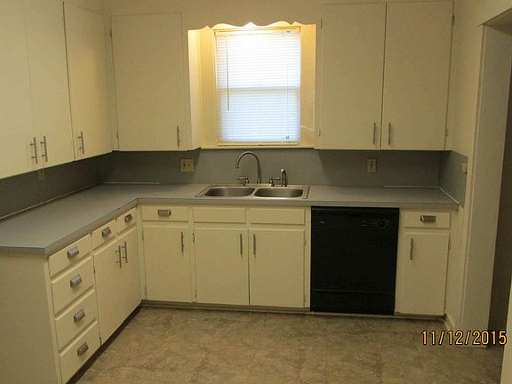 Kitchen cabinets, sink & dishwasher.