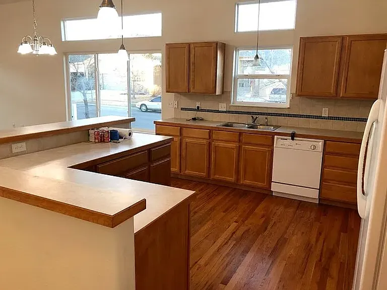 View of the kitchen from the garage entry door.