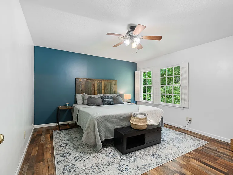 Bedroom 2, shares wall with primary bedroom. Windows face back lawn.