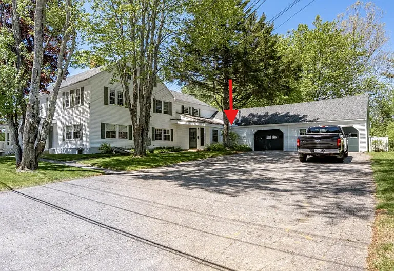 arrow points to front entrance and attached garage bay