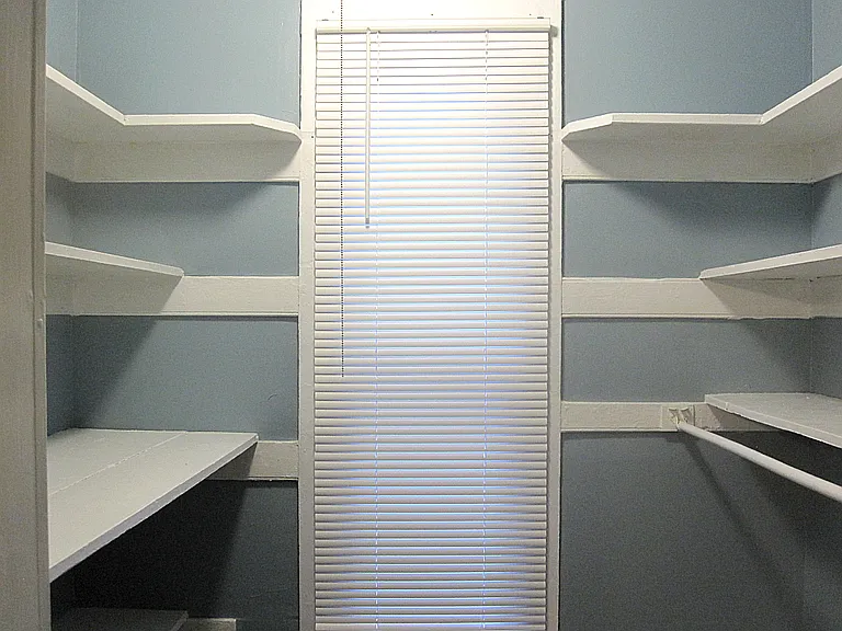 Pantry room with shelving, attached to kitchen.