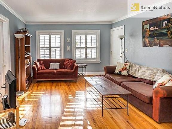 A spacious living space with newer windows, plantation shutters and wood floors!