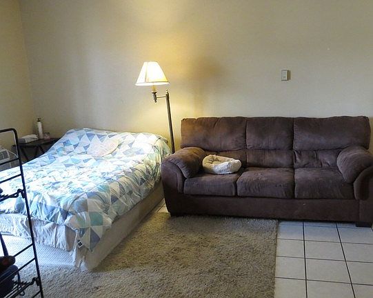Current occupant using living room as bedroom/living room combo