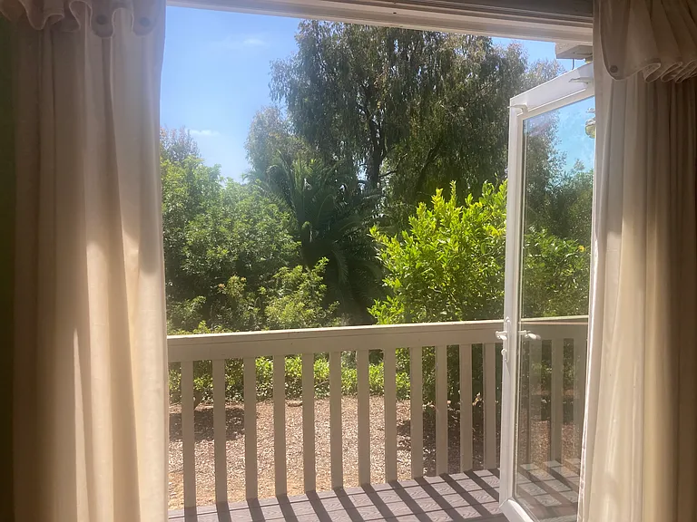 Master bedroom with french doors that open to fenced patio with gate.