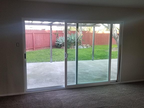 Oversized 10 foot sliding glass door that opens onto a private and covered patio