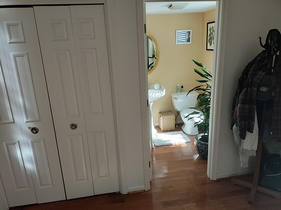 Ist floor powder room/half bath off foyer. Stainless steel Samsung washer and dryer to the left of the powder room behind folding doors.