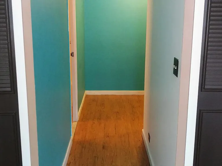 Hallway to bedroom with large sitting area