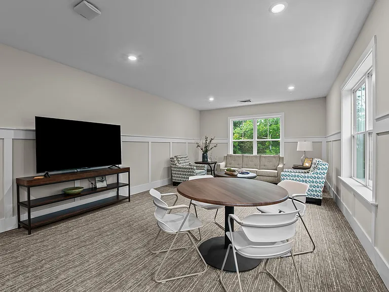 Active Adult conference room with tables and chairs and a television