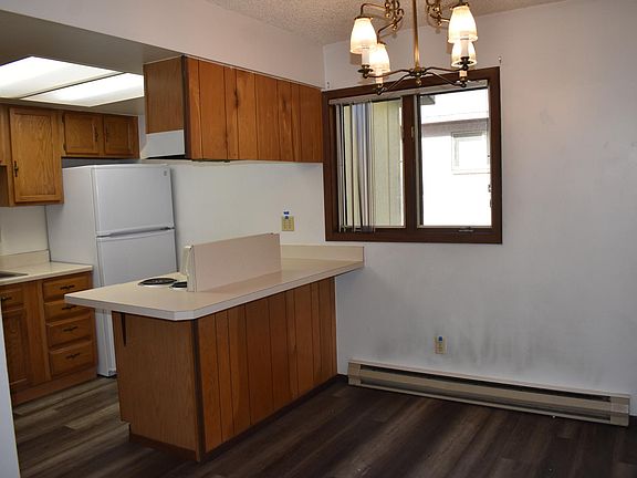 Small kitchen. Fridge is pretty new. Stove and cabinets old.